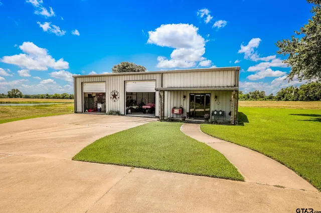 a view of a house with a swimming pool and a yard
