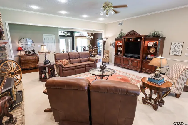 a bedroom with a bed a flat screen tv and dresser