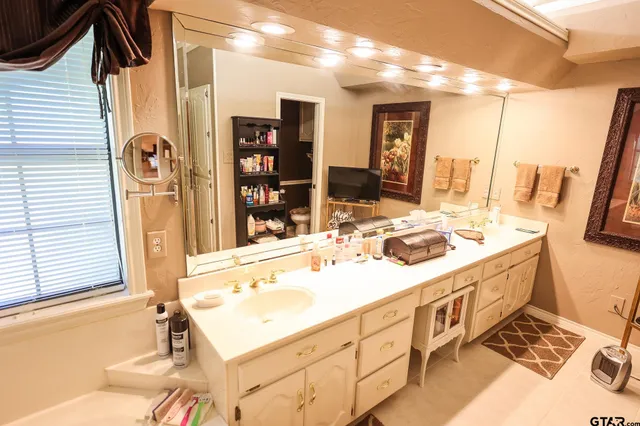 a spacious bedroom with a bed and wooden floor