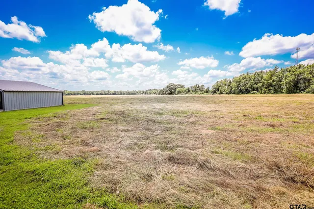 a view of a house with yard and sitting area