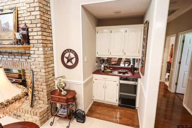 a living room with furniture a flat screen tv and a chandelier