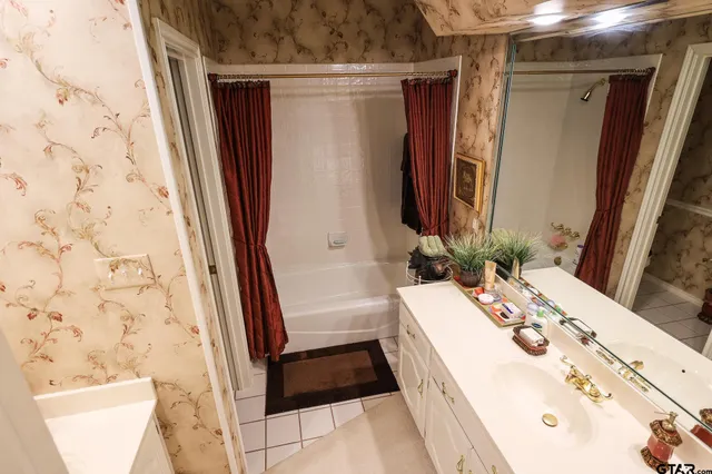 a living room with furniture a flat screen tv and a chandelier