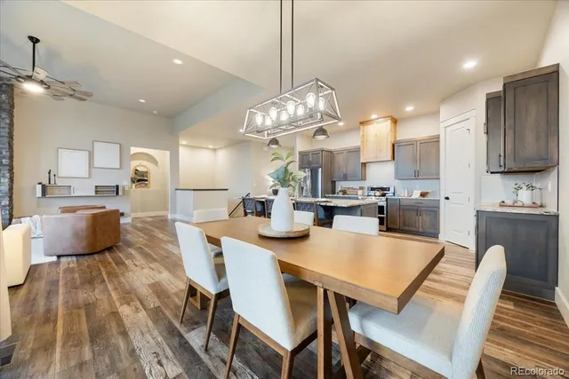 a large kitchen with kitchen island a dining table and chairs