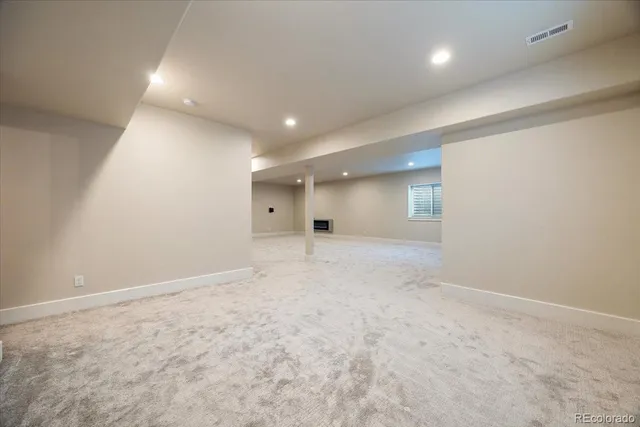 an empty room with an entryway and fan