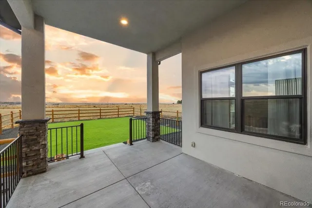 a view of a porch and floor to ceiling window