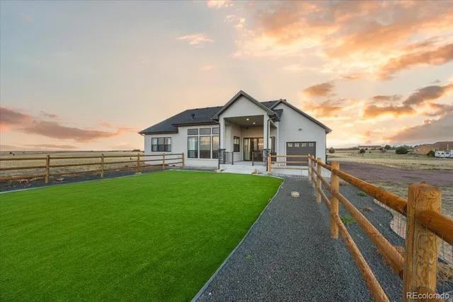a view of an house with backyard space and garden