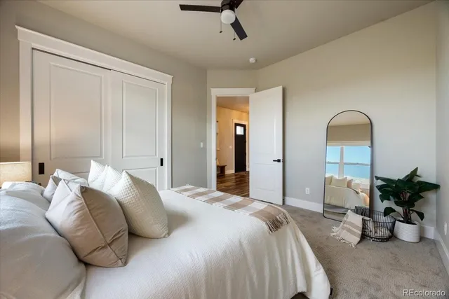 a bedroom with bed and a potted plant