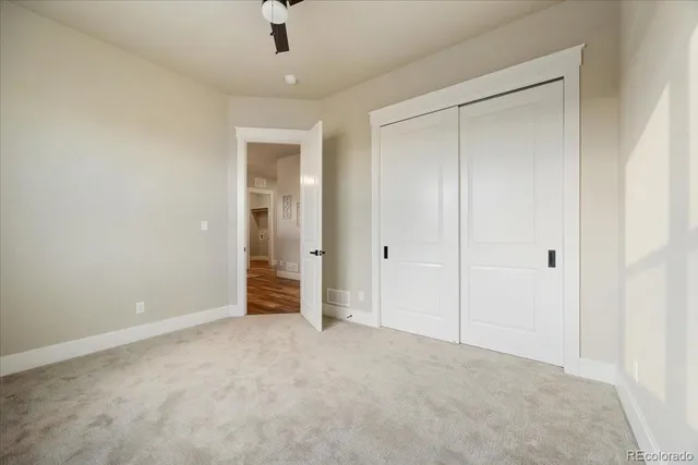 a view of an empty room and closet area