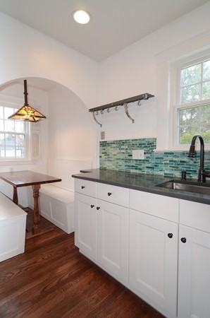 239 Weston Road Wellesley, MA 02482 - Photo 8 of 17 a kitchen with white cabinets and window