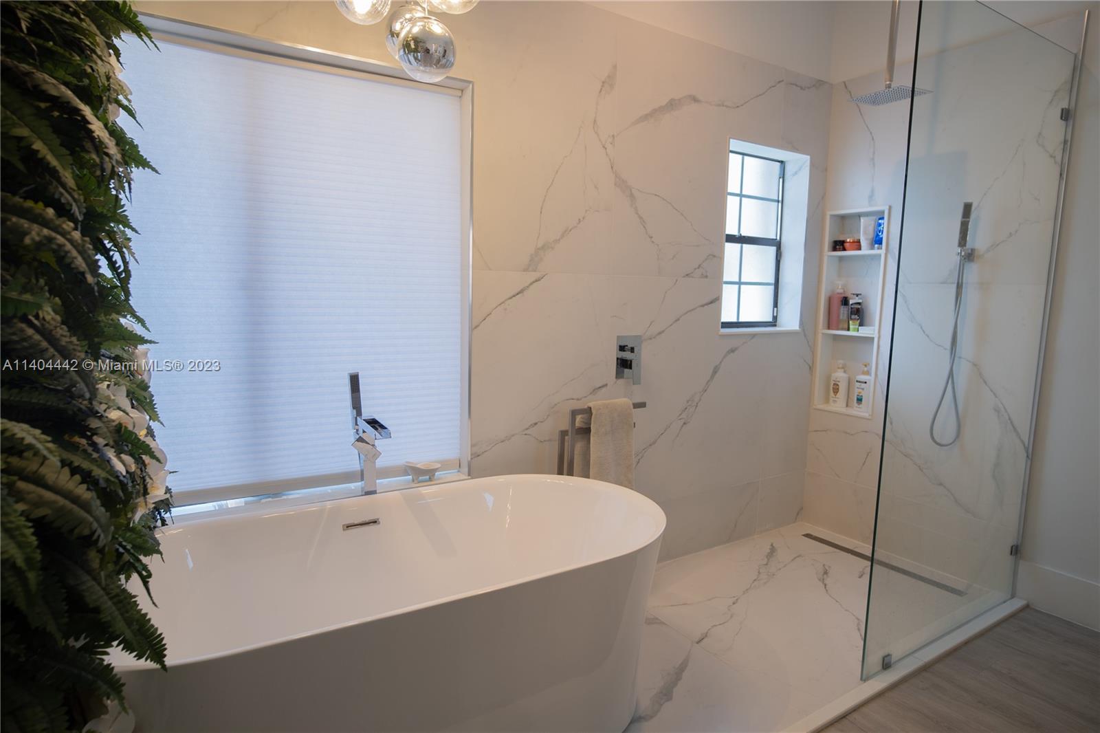 10684 Santa Laguna Drive Boca Raton, FL 33428 - Photo 20 of 39 a bathroom with a sink and shower