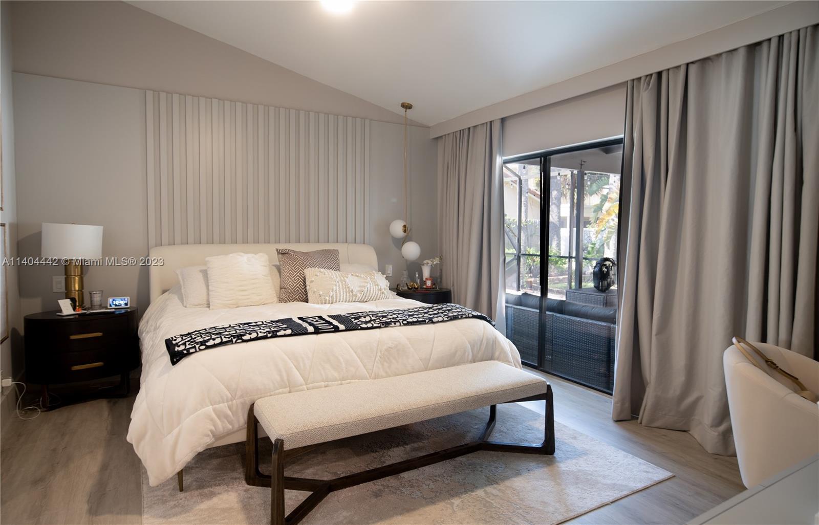 10684 Santa Laguna Drive Boca Raton, FL 33428 - Photo 22 of 39 a bedroom with a bed lamp and a large window