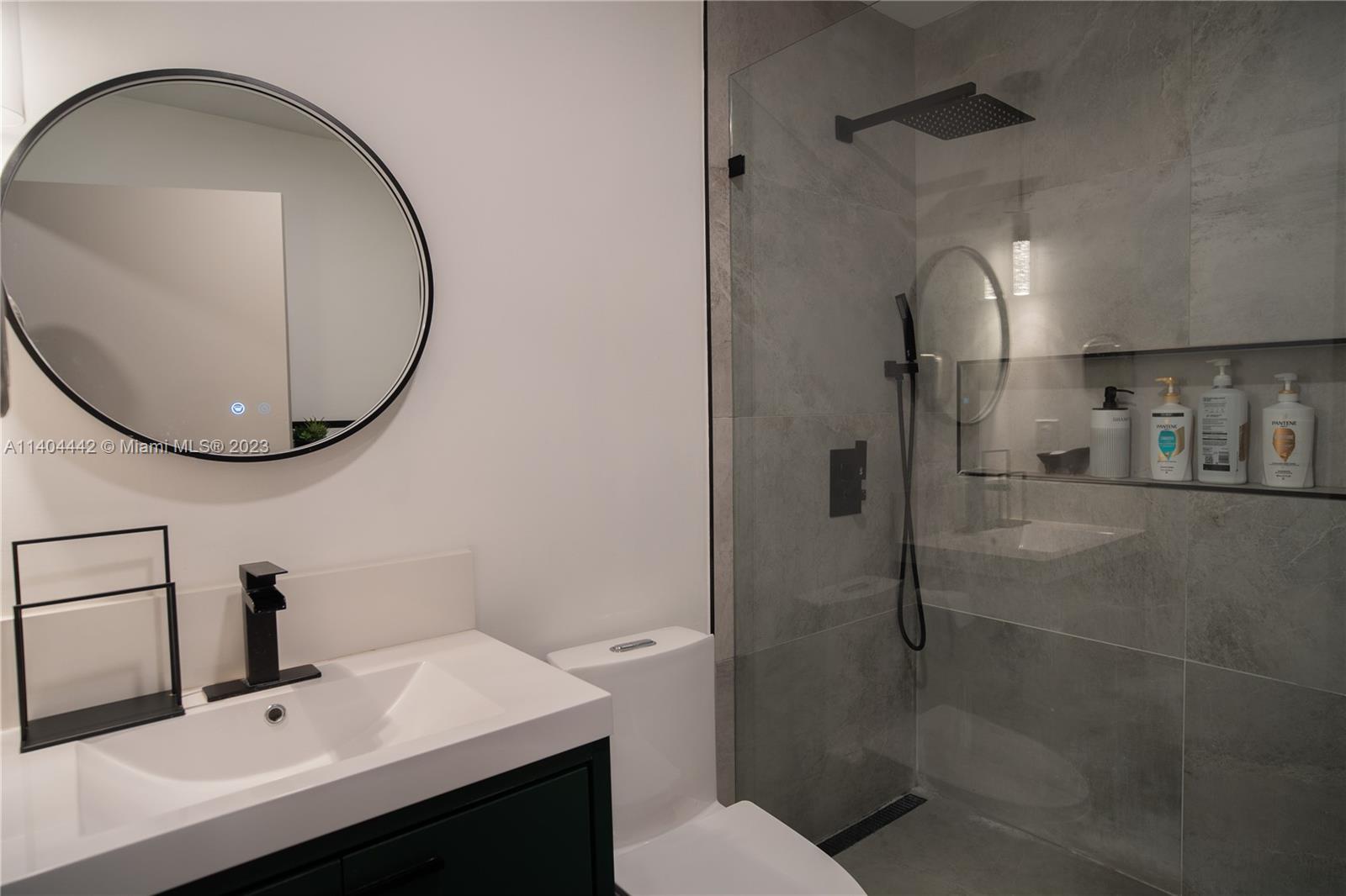 10684 Santa Laguna Drive Boca Raton, FL 33428 - Photo 25 of 39 a bathroom with a sink toilet and a mirror