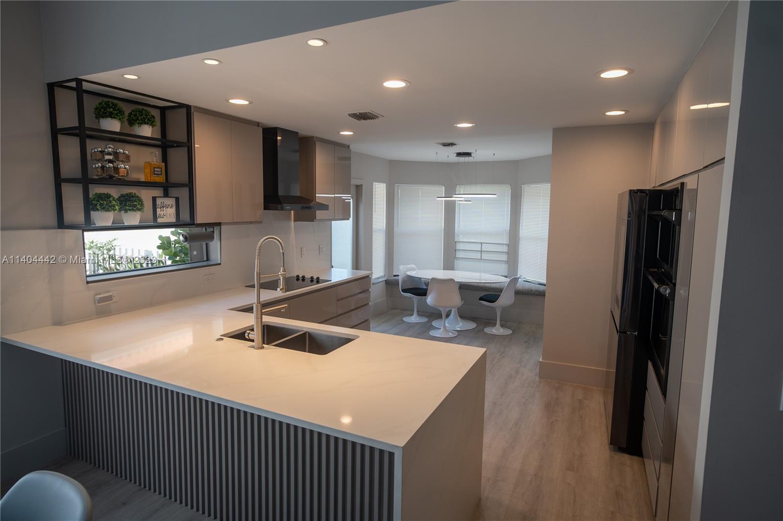 10684 Santa Laguna Drive Boca Raton, FL 33428 - Photo 3 of 39 a kitchen with kitchen island a sink stainless steel appliances and cabinets