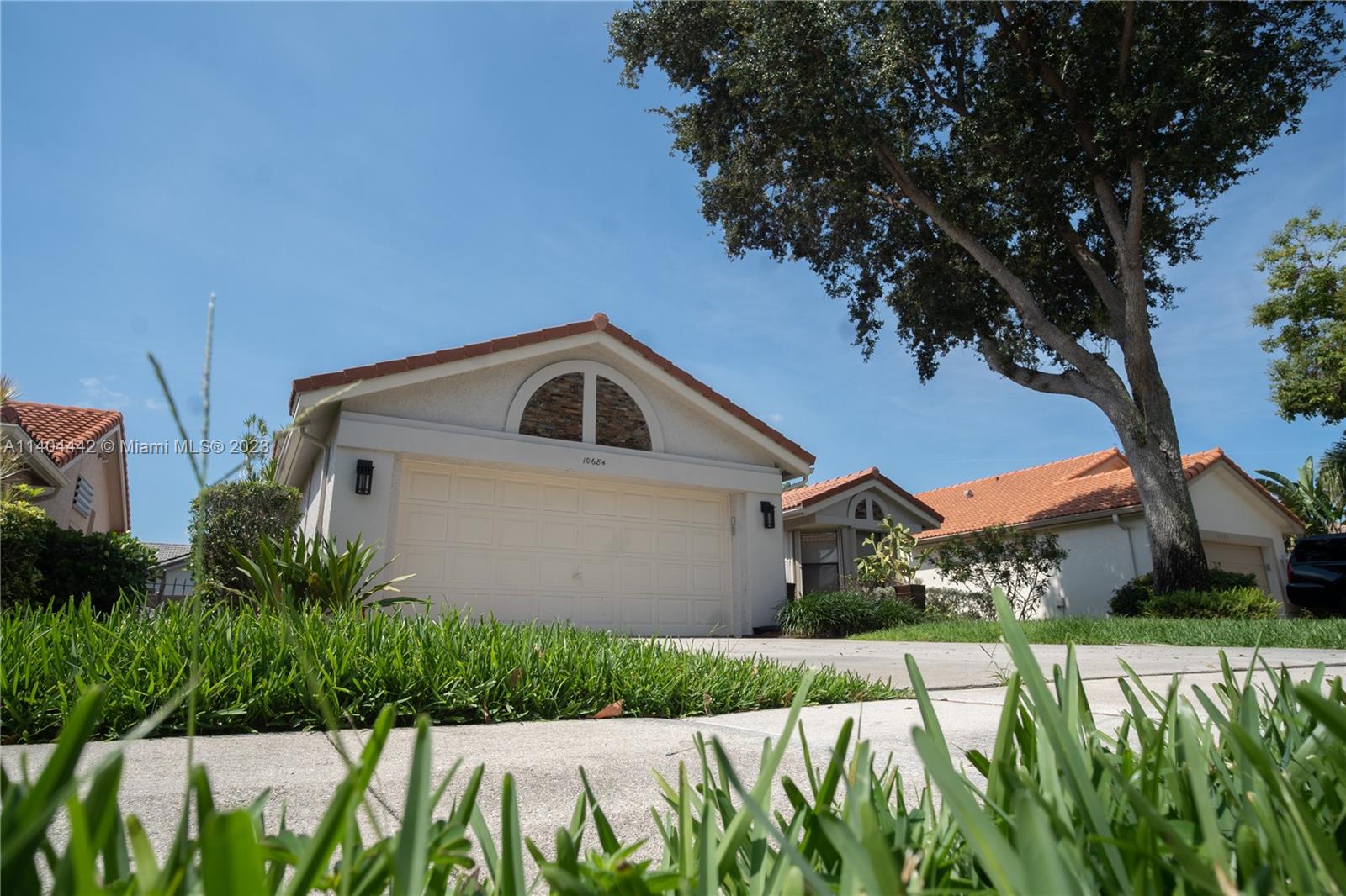 10684 Santa Laguna Drive Boca Raton, FL 33428 - Photo 31 of 39 a front view of a house with a yard