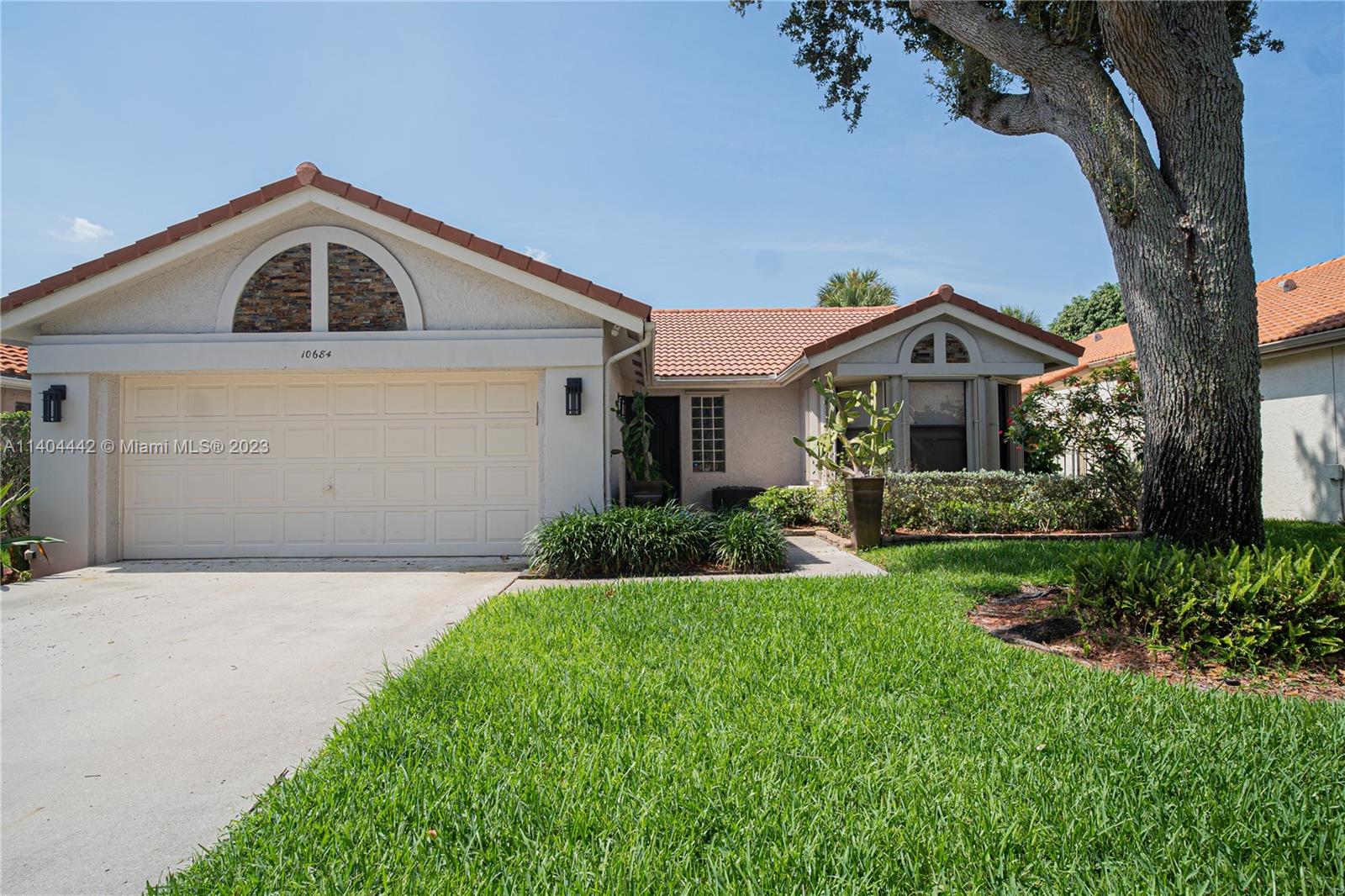 10684 Santa Laguna Drive Boca Raton, FL 33428 - Photo 32 of 39 a front view of a house with a yard