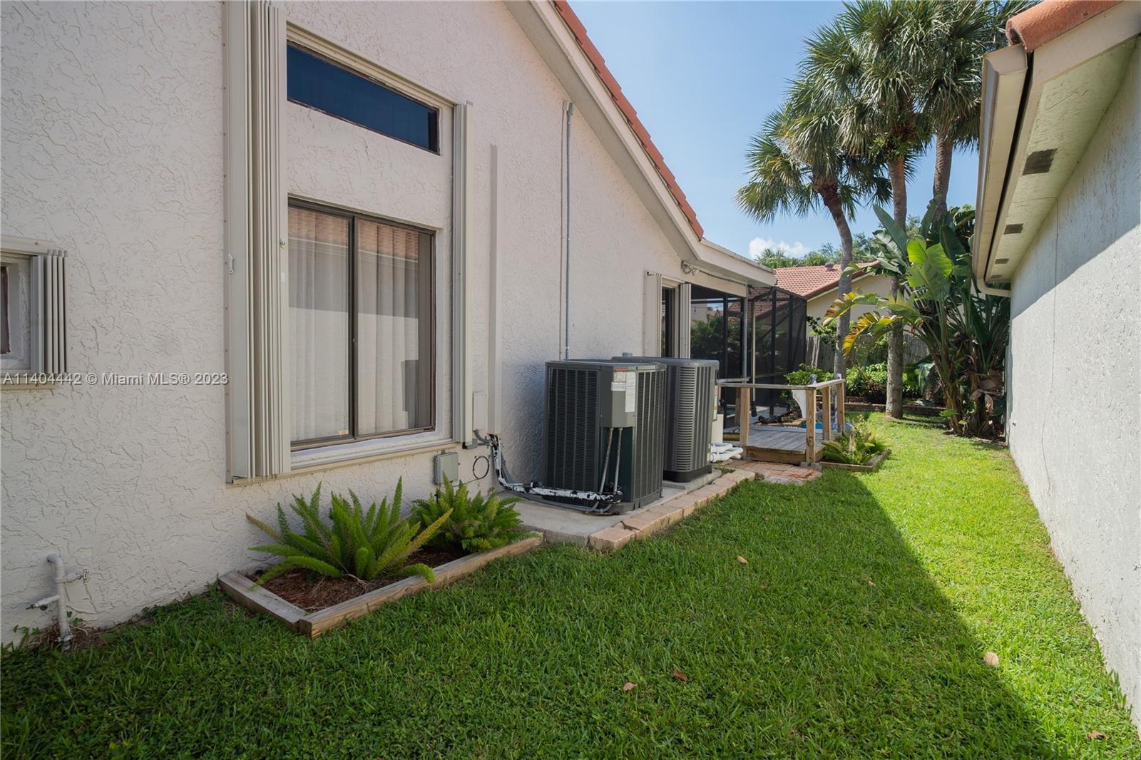 10684 Santa Laguna Drive Boca Raton, FL 33428 - Photo 34 of 39 a front view of a house with garden