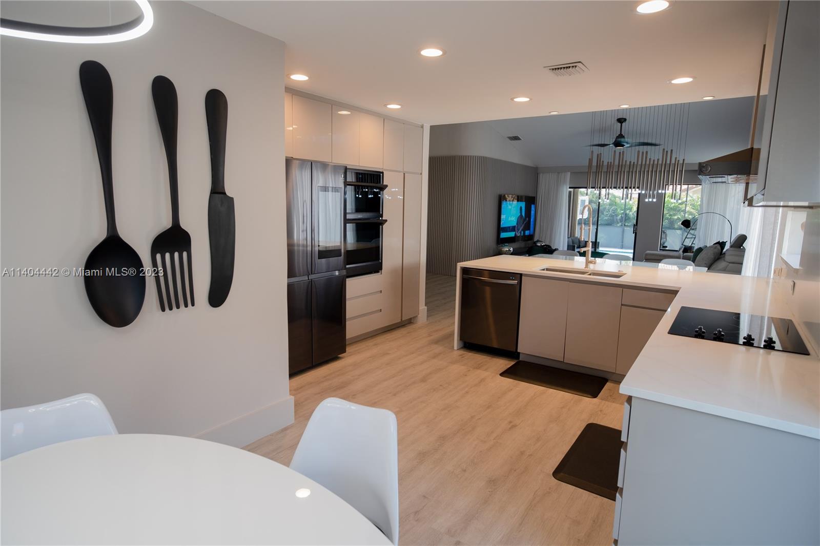 10684 Santa Laguna Drive Boca Raton, FL 33428 - Photo 6 of 39 a living room with stainless steel appliances furniture and a flat screen tv