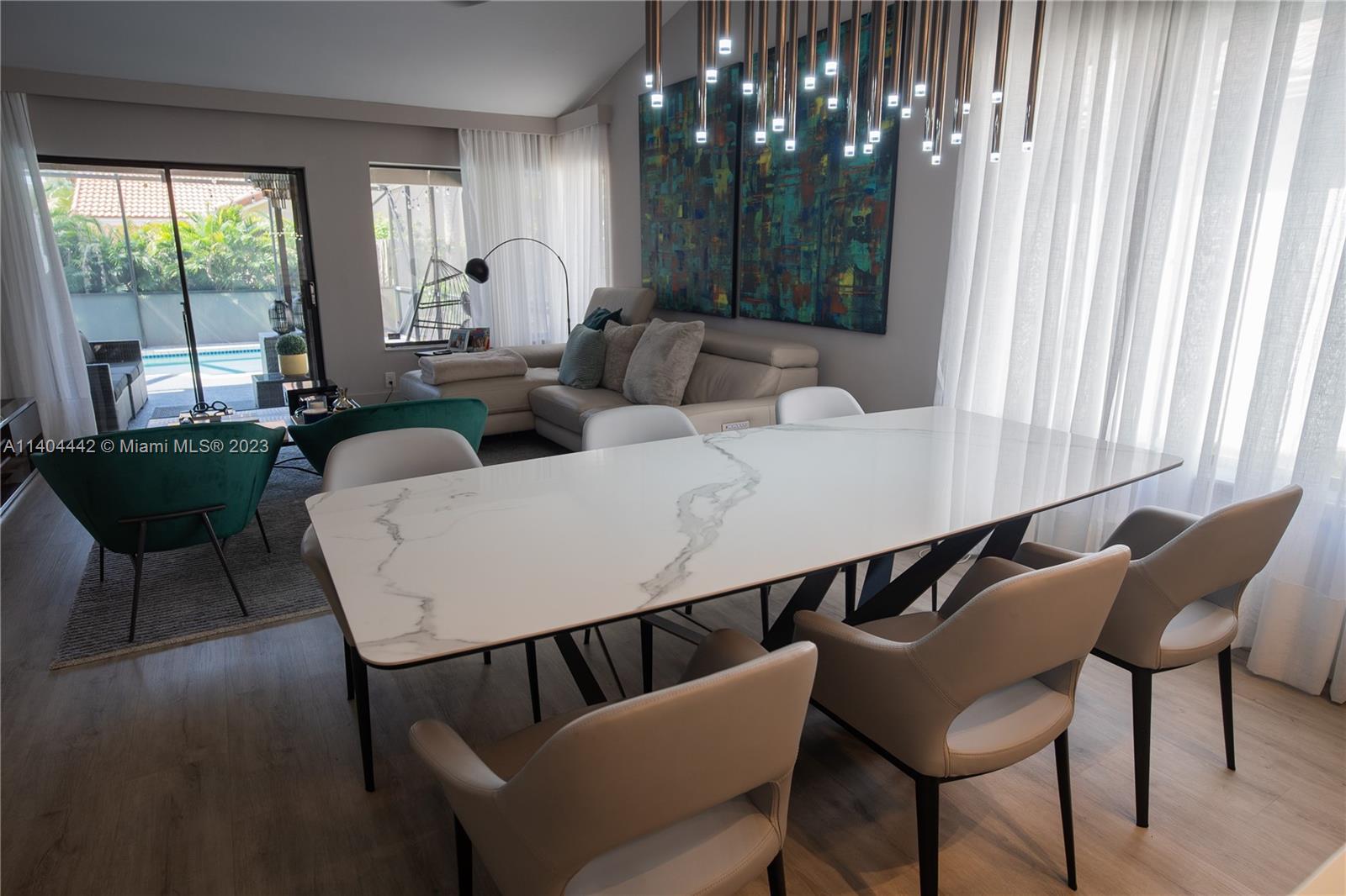 10684 Santa Laguna Drive Boca Raton, FL 33428 - Photo 8 of 39 a view of a dining room with furniture and a large window
