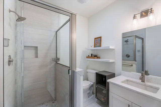 a bathroom with a sink mirror and toilet