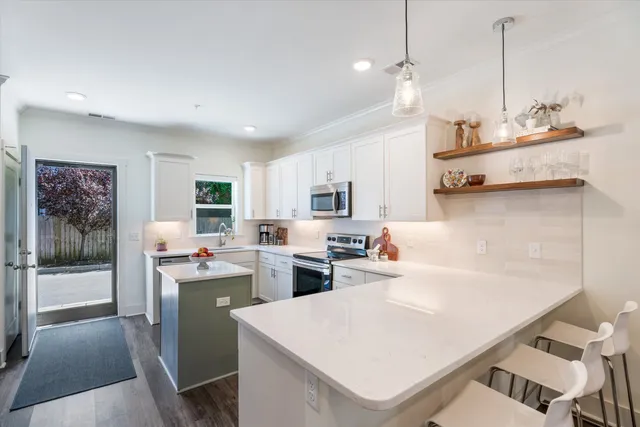 a kitchen with a sink appliances and cabinets