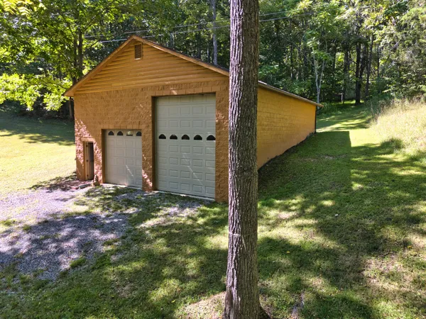 a view of a small house with a yard