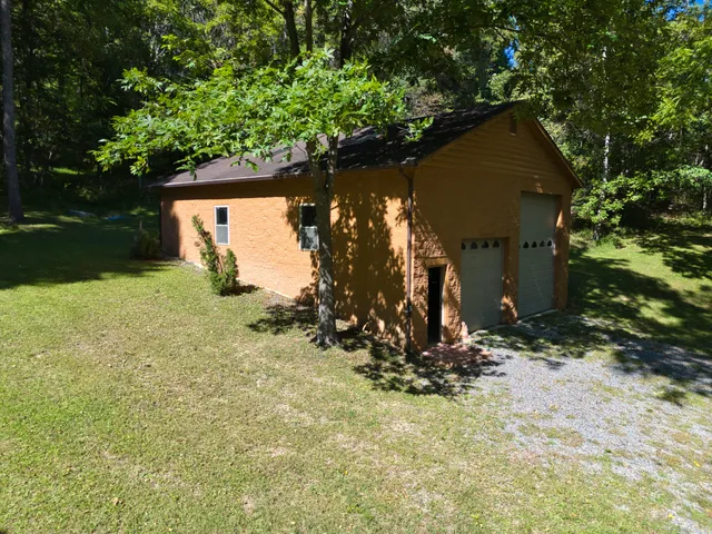 a view of a wooden house with a yard
