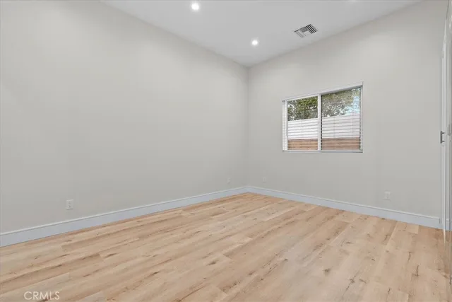a bathroom with a granite countertop toilet a sink a mirror and vanity