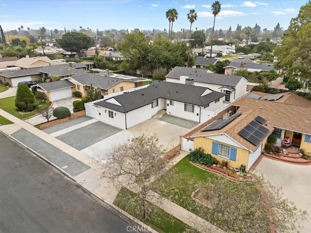 an aerial view of a house with a yard swimming pool and mountain view