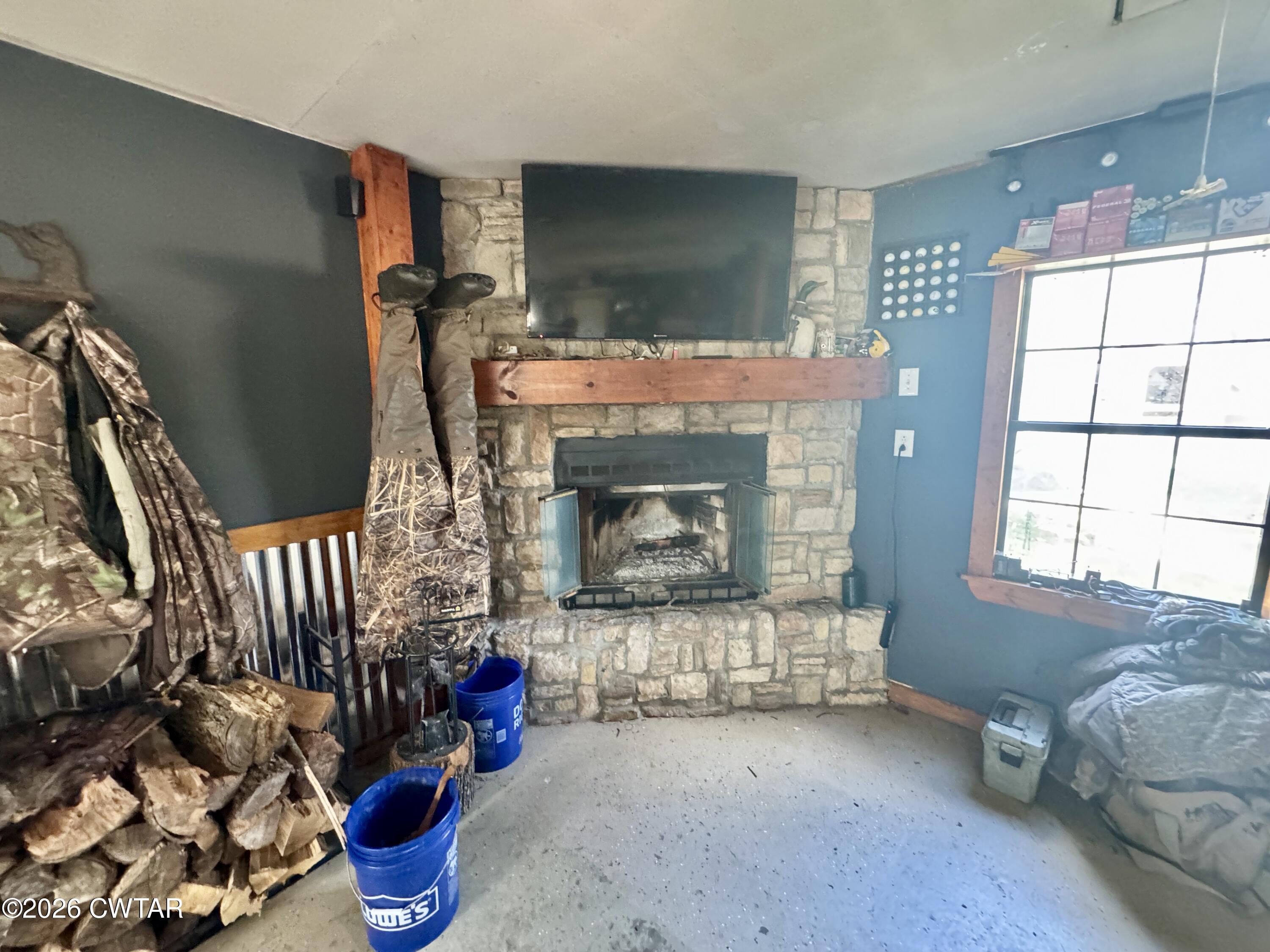 235 Tate Road Dyersburg, TN 38024 - Photo 11 of 34 a living room with furniture a flat screen tv and a fireplace