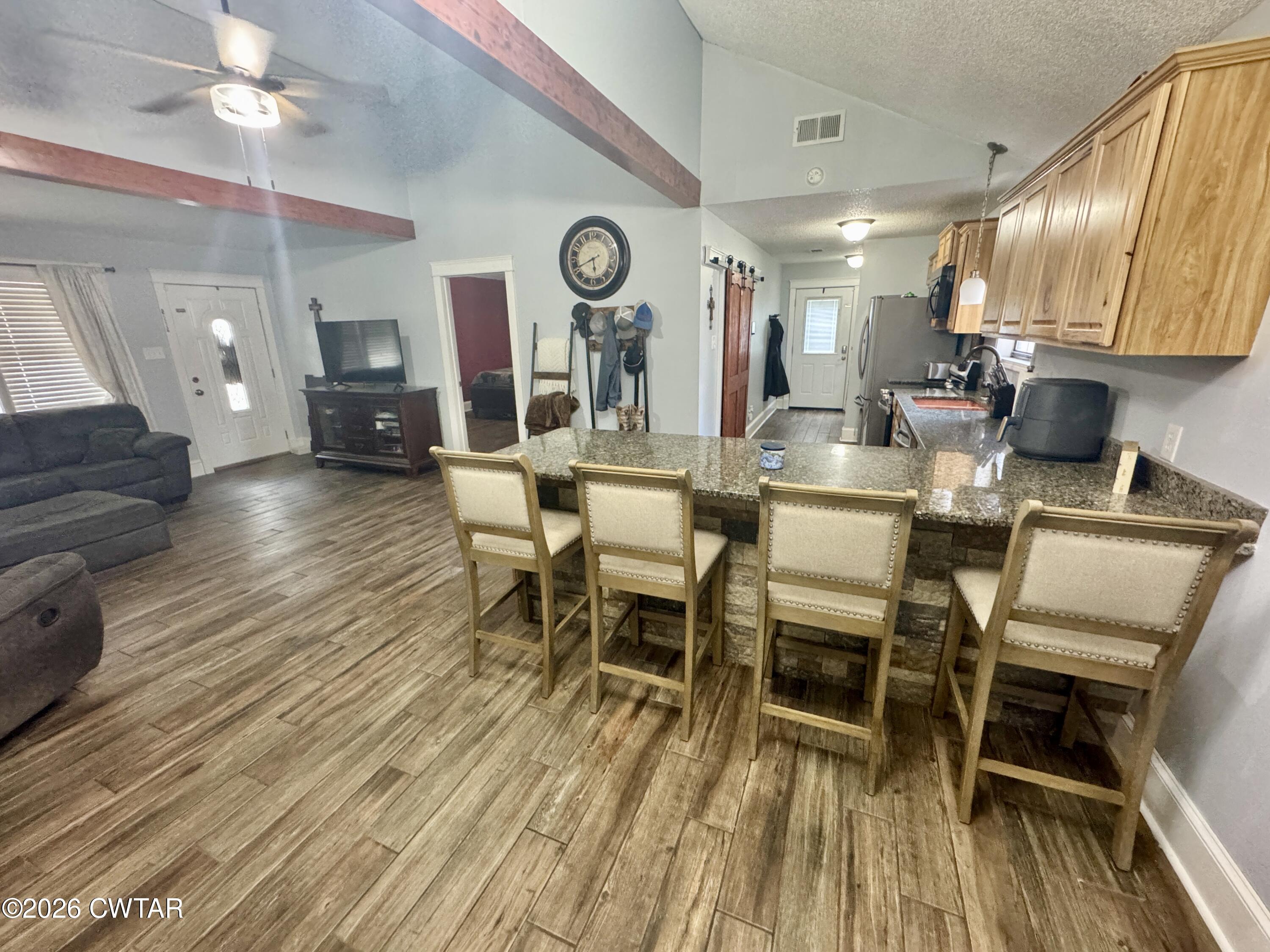 235 Tate Road Dyersburg, TN 38024 - Photo 20 of 34 a dining room with furniture a rug and wooden floor