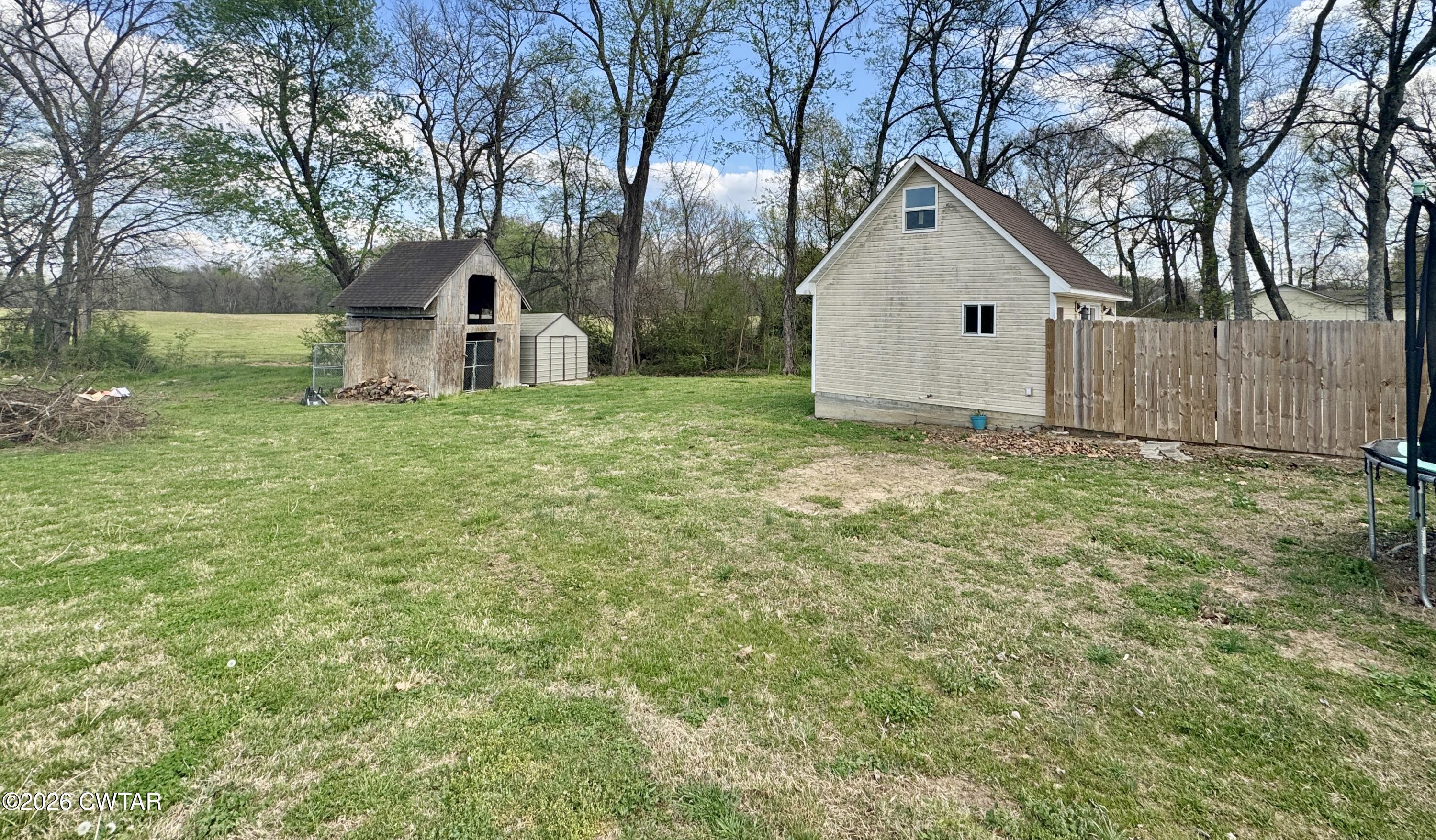 235 Tate Road Dyersburg, TN 38024 - Photo 27 of 34 a view of a house with yard and a tree