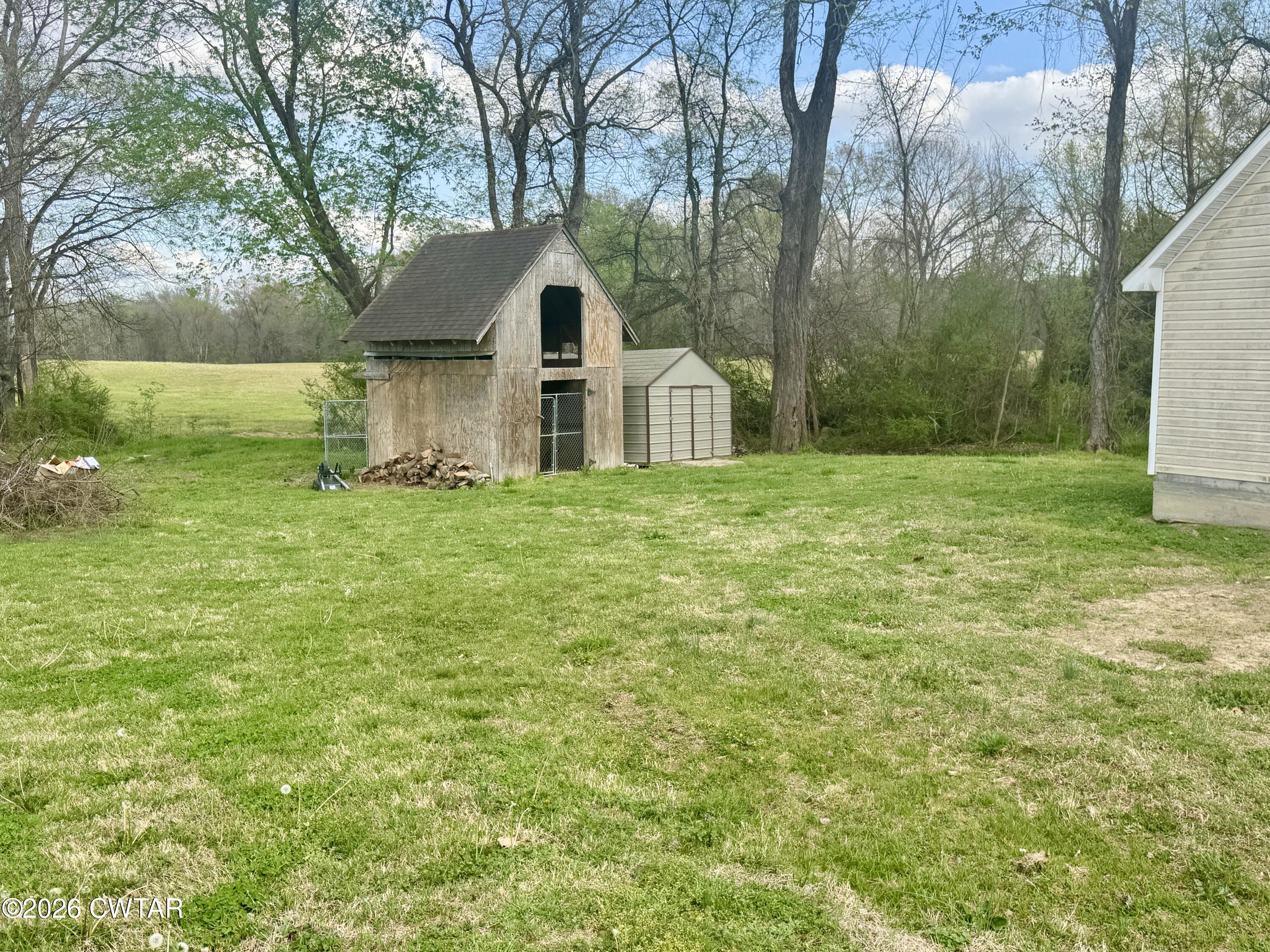 235 Tate Road Dyersburg, TN 38024 - Photo 28 of 34 a front view of a house with yard and green space