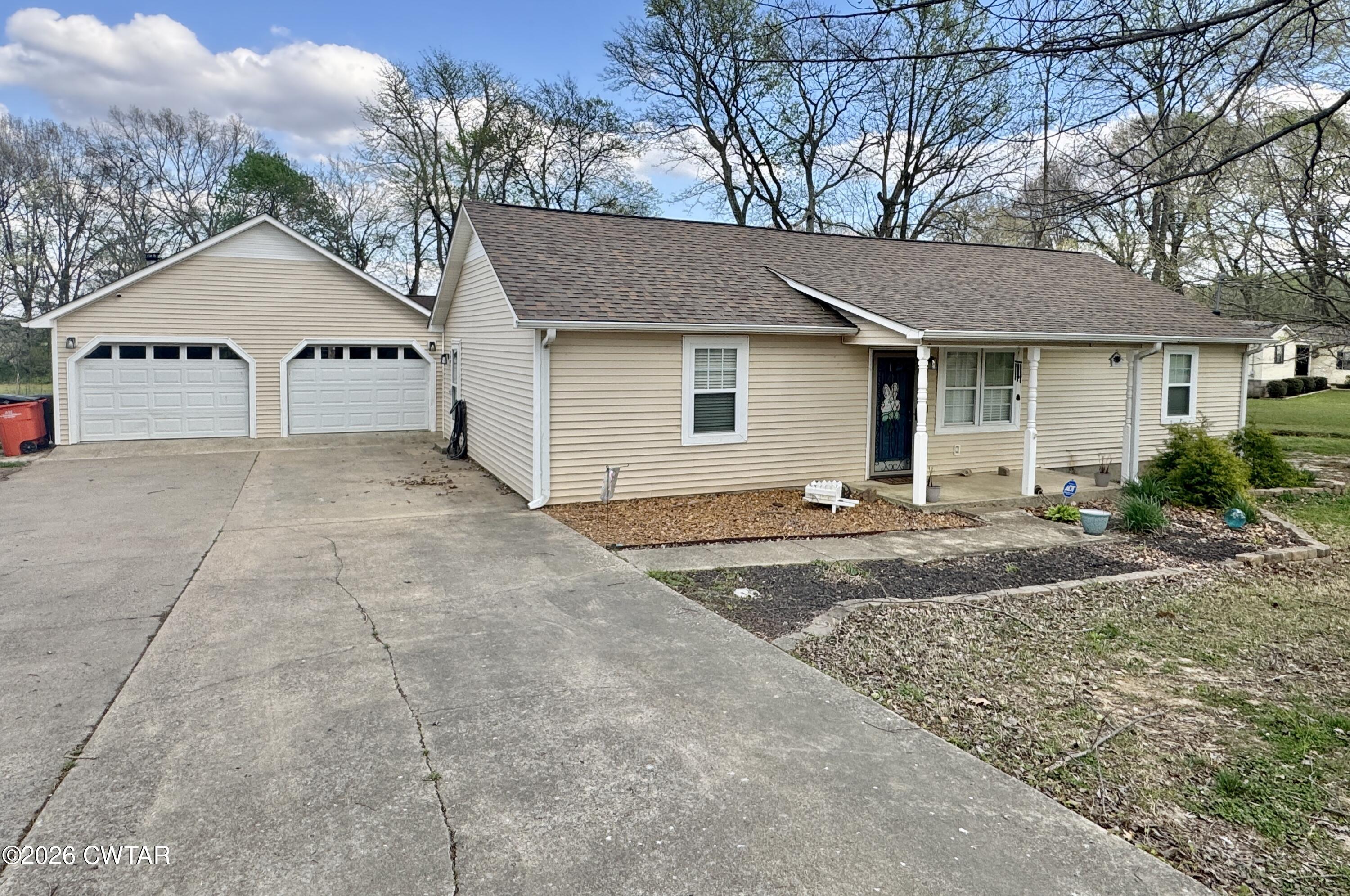 235 Tate Road Dyersburg, TN 38024 - Photo 3 of 34 a front view of a house with a yard and garage