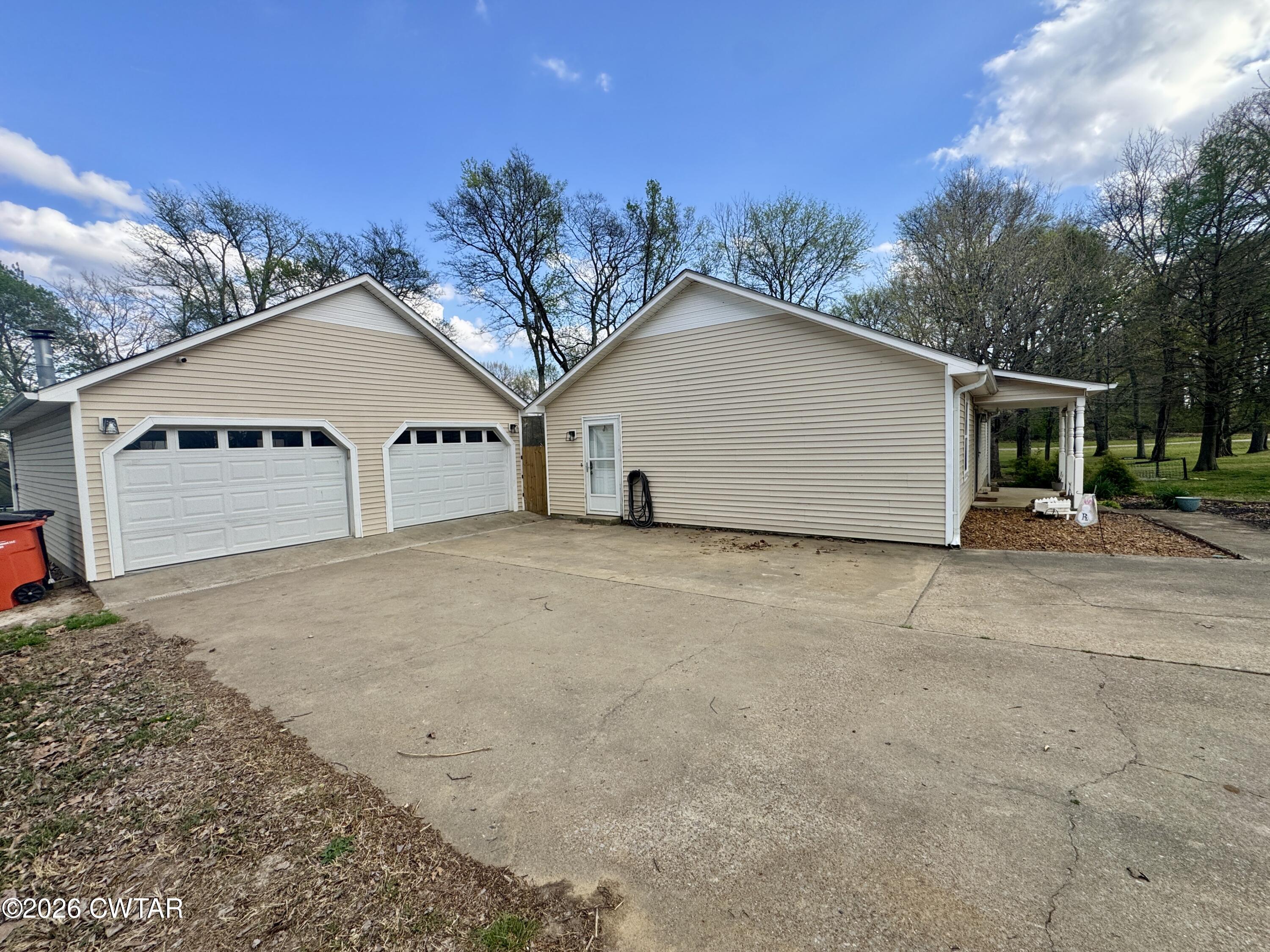 235 Tate Road Dyersburg, TN 38024 - Photo 32 of 34 a view of a house with a yard and garage