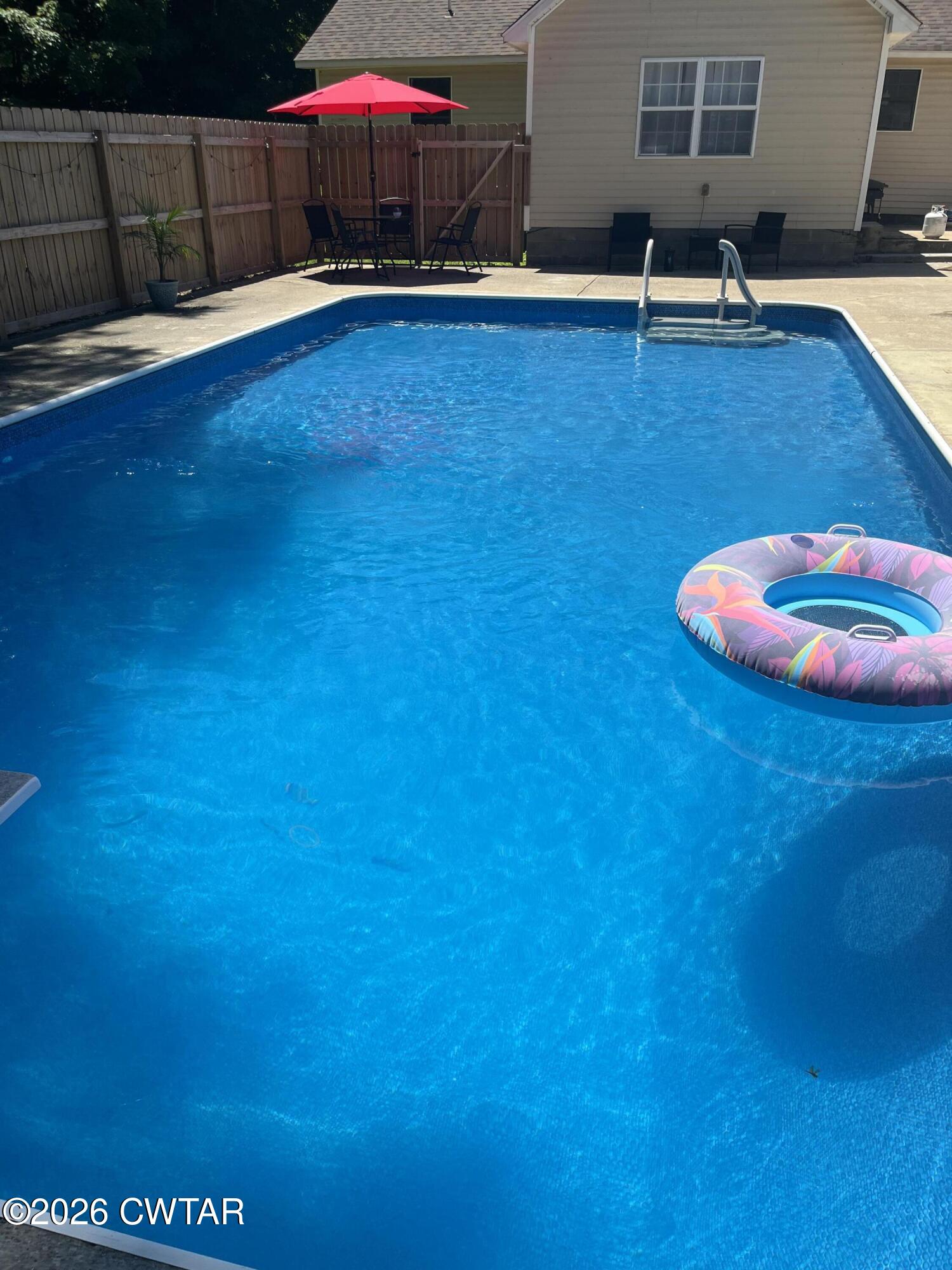 235 Tate Road Dyersburg, TN 38024 - Photo 4 of 34 a view of a swimming pool with an outdoor space and seating area