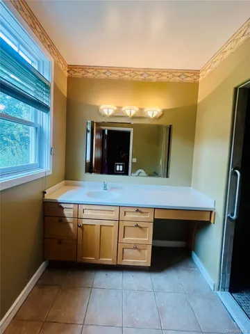 a view of kitchen with stainless steel appliances granite countertop a sink and a refrigerator
