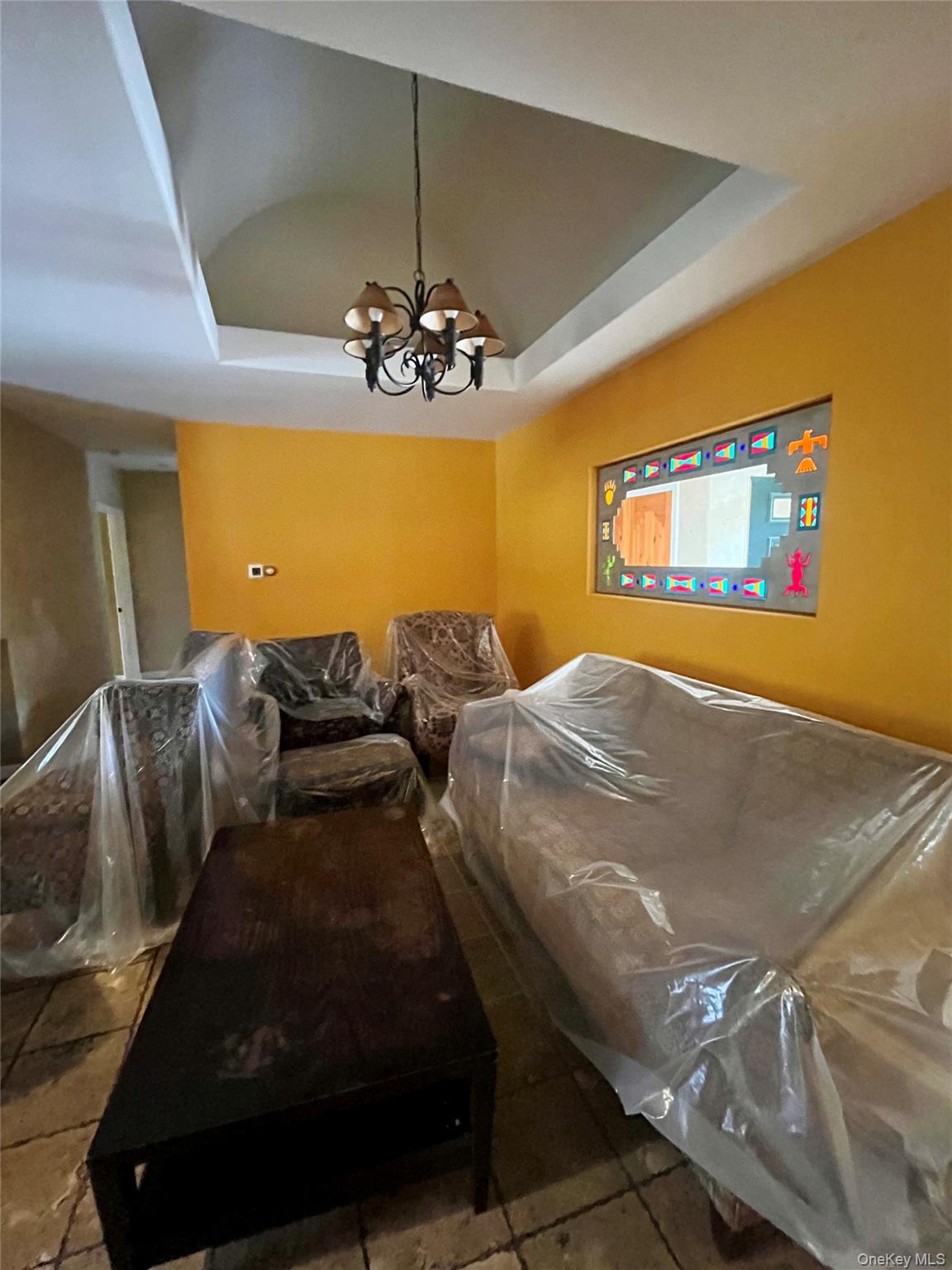 769 Bullville Road Montgomery, NY 12549 - Photo 18 of 19 a bedroom with double bed and a chandelier