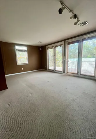 a view of an empty room with a window