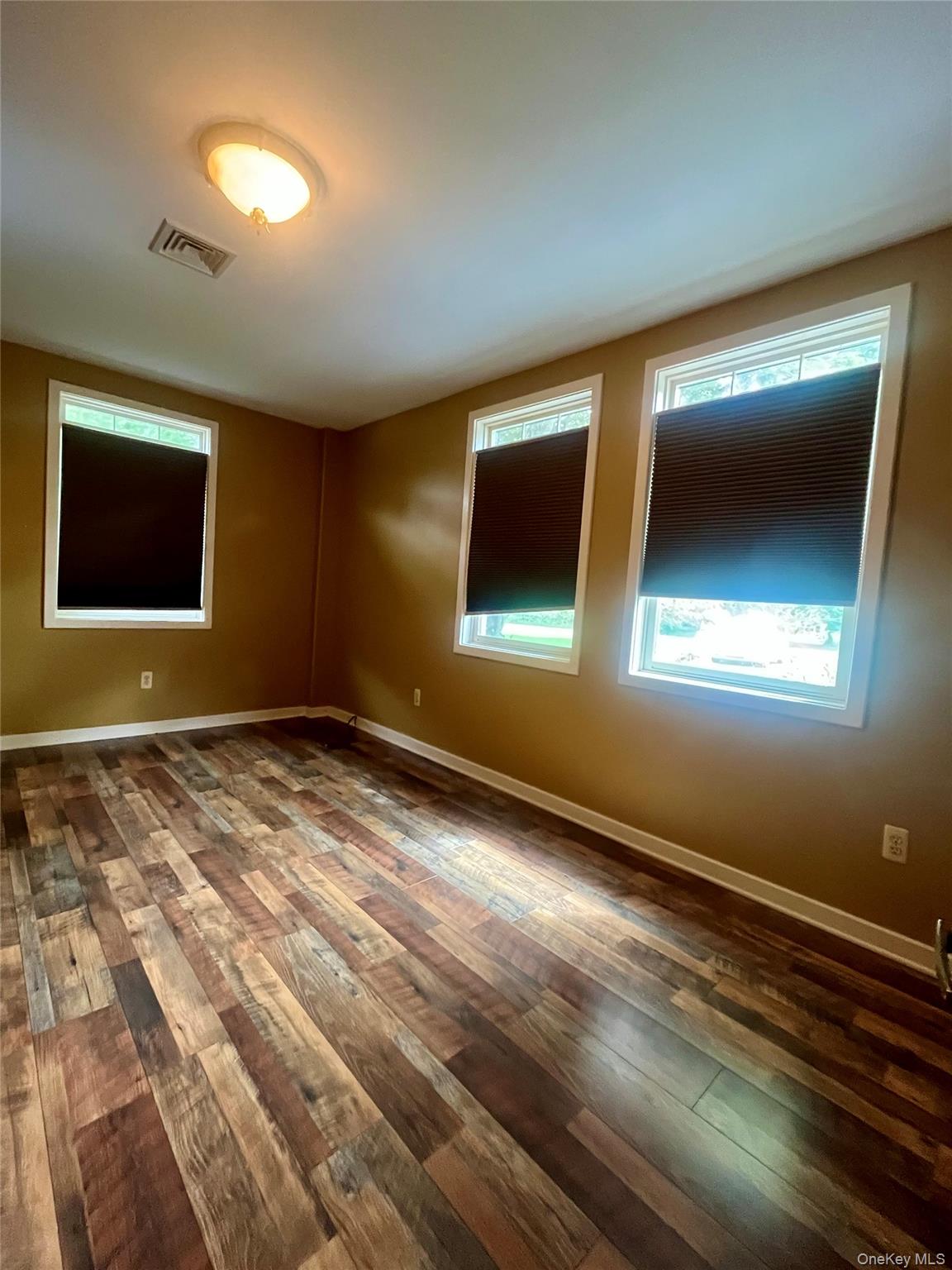 769 Bullville Road Montgomery, NY 12549 - Photo 10 of 19 a view of an empty room with window and wooden floor