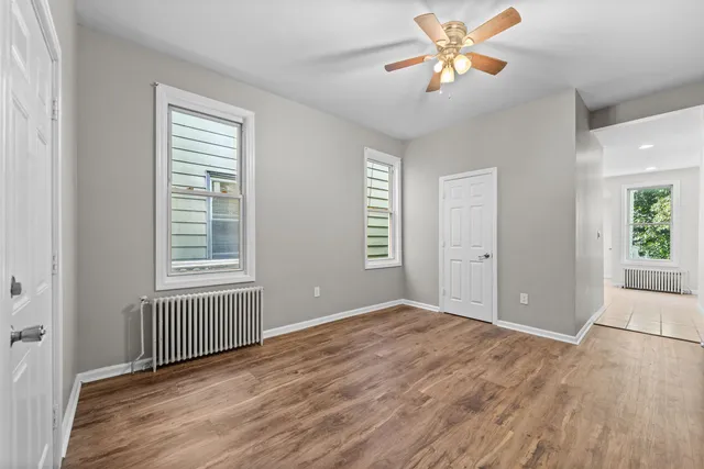 wooden floor in an empty room with a window