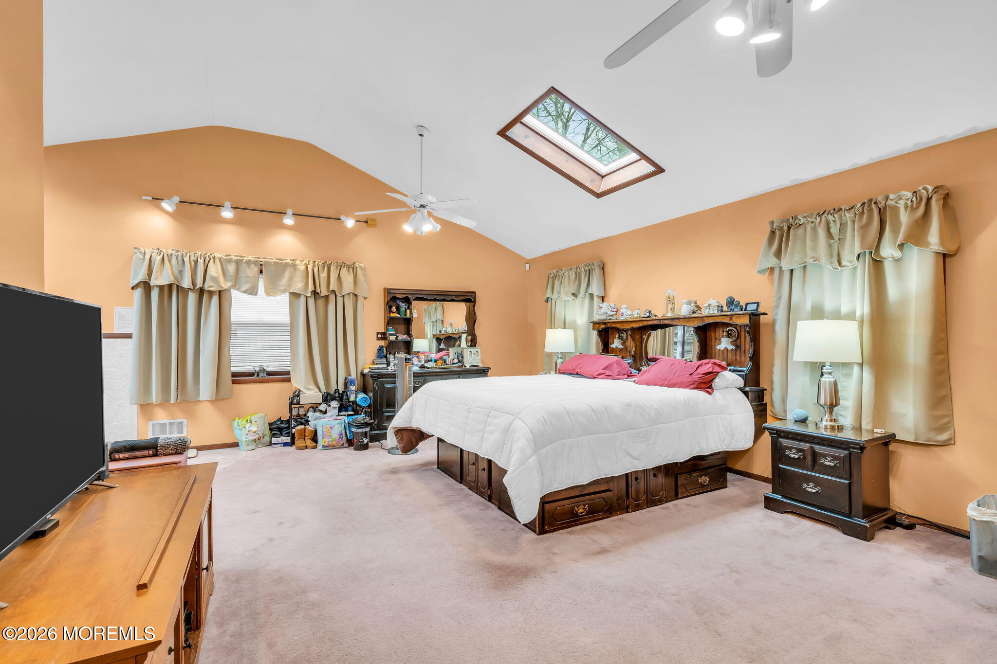 203 Freehold Road Jackson, NJ 08527 - Photo 17 of 33 a spacious bedroom with a bed and a chandelier