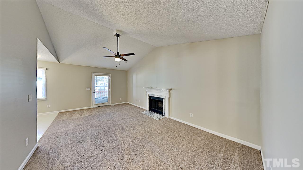 4104 Old Coach Road Raleigh, NC 27616 - Photo 2 of 9 a view of a livingroom with a fireplace and window
