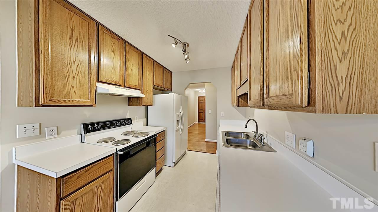 4104 Old Coach Road Raleigh, NC 27616 - Photo 3 of 9 a kitchen that has a sink a stove and a refrigerator