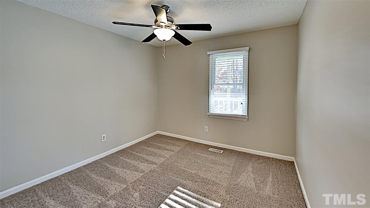 4104 Old Coach Road Raleigh, NC 27616 - Photo 6 of 9 an empty room with a window and a fan