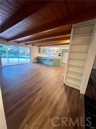 a view of a room with wooden floor