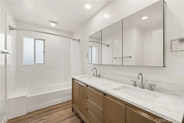 a bathroom with a sink a mirror and a window