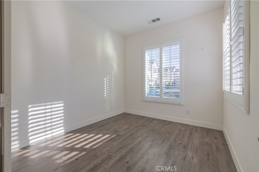 4 Lavanda Street Rancho Mission Viejo, CA 92694 - Photo 12 of 43 a view of an empty room with wooden floor and a window