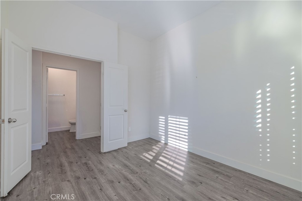 4 Lavanda Street Rancho Mission Viejo, CA 92694 - Photo 13 of 43 a view of an empty room with wooden floor and a window