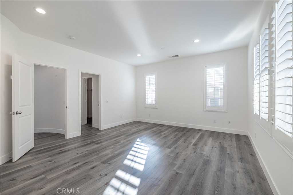 4 Lavanda Street Rancho Mission Viejo, CA 92694 - Photo 19 of 43 an empty room with wooden floor and windows