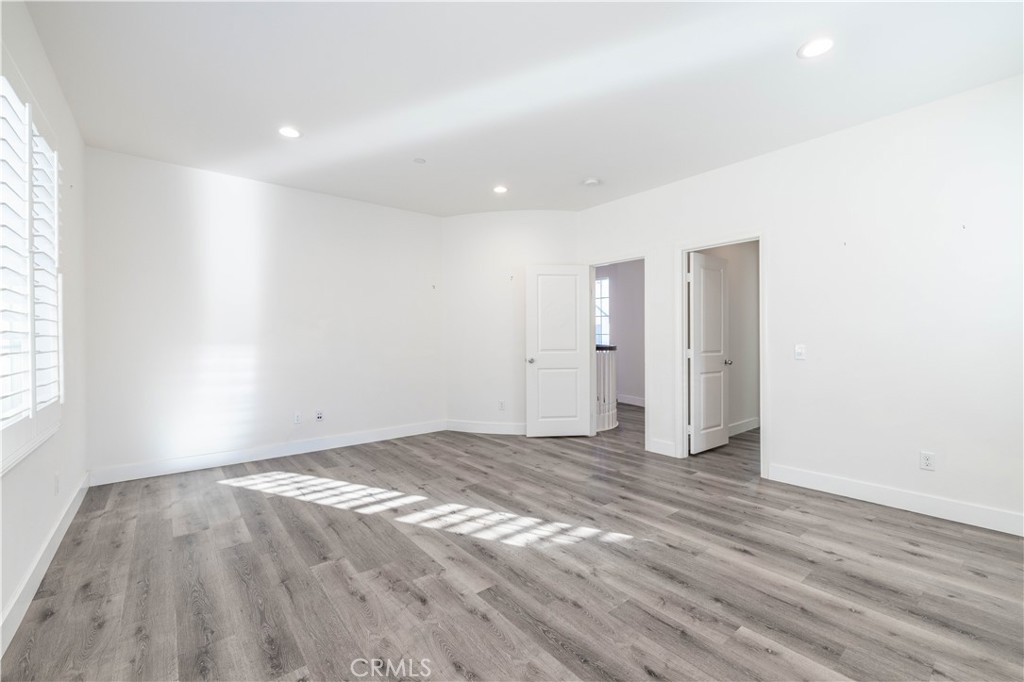 4 Lavanda Street Rancho Mission Viejo, CA 92694 - Photo 21 of 43 a view of an empty room with wooden floor and a window